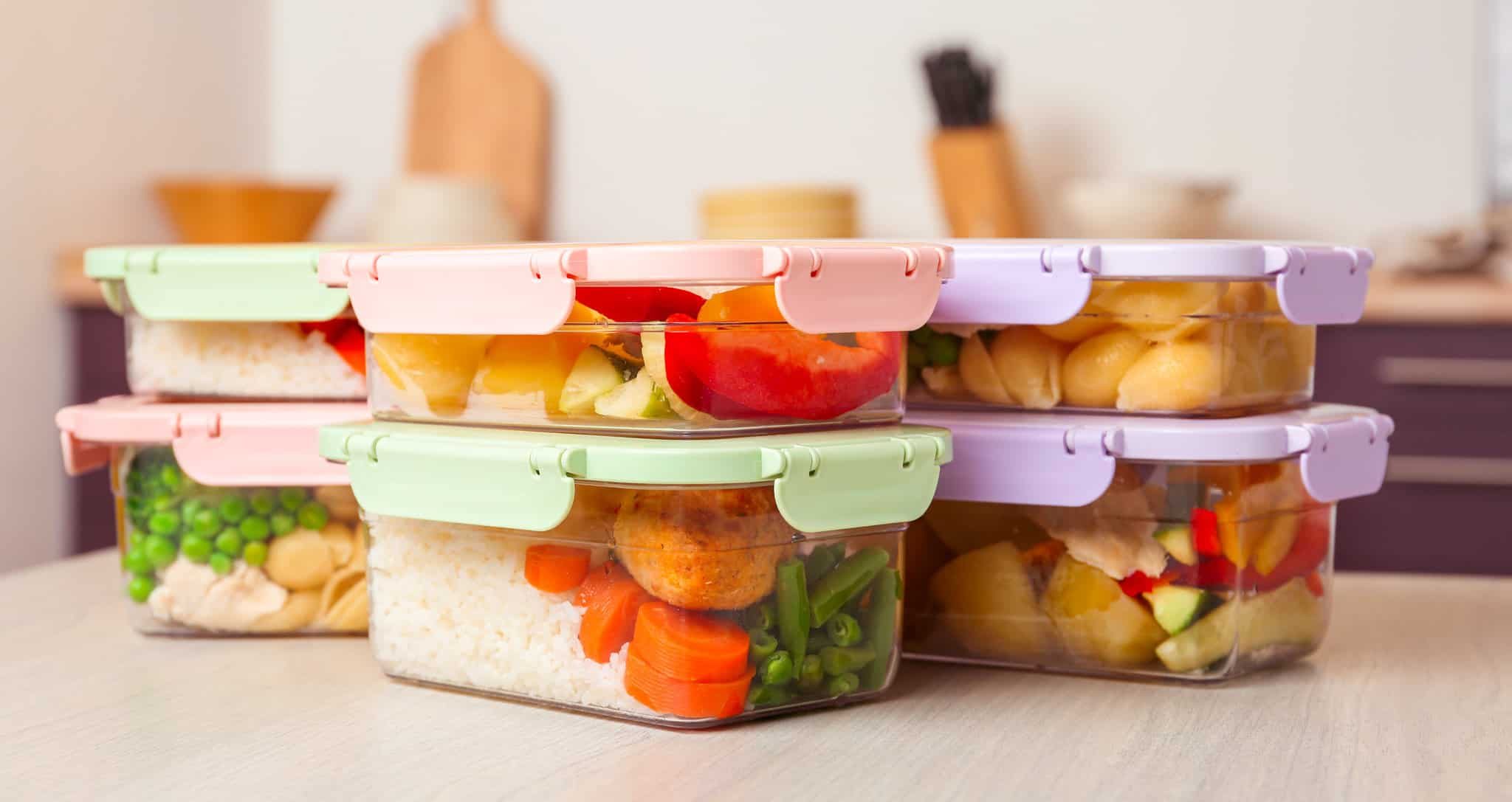 Boxes with prepared meals on table against blurred background